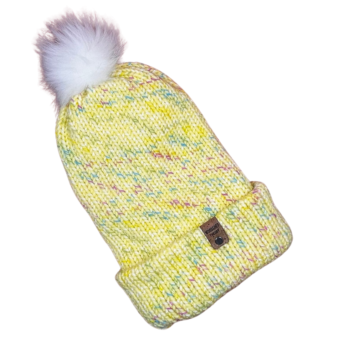 Yellow knitted beanie with a pom-pom on a white background spring chunky beanie yellow front