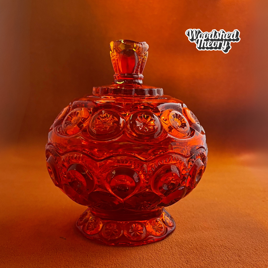 Vintage L.E. Smith Moon & Stars red glass lidded compote candy dish with cadmium glow under black light side view