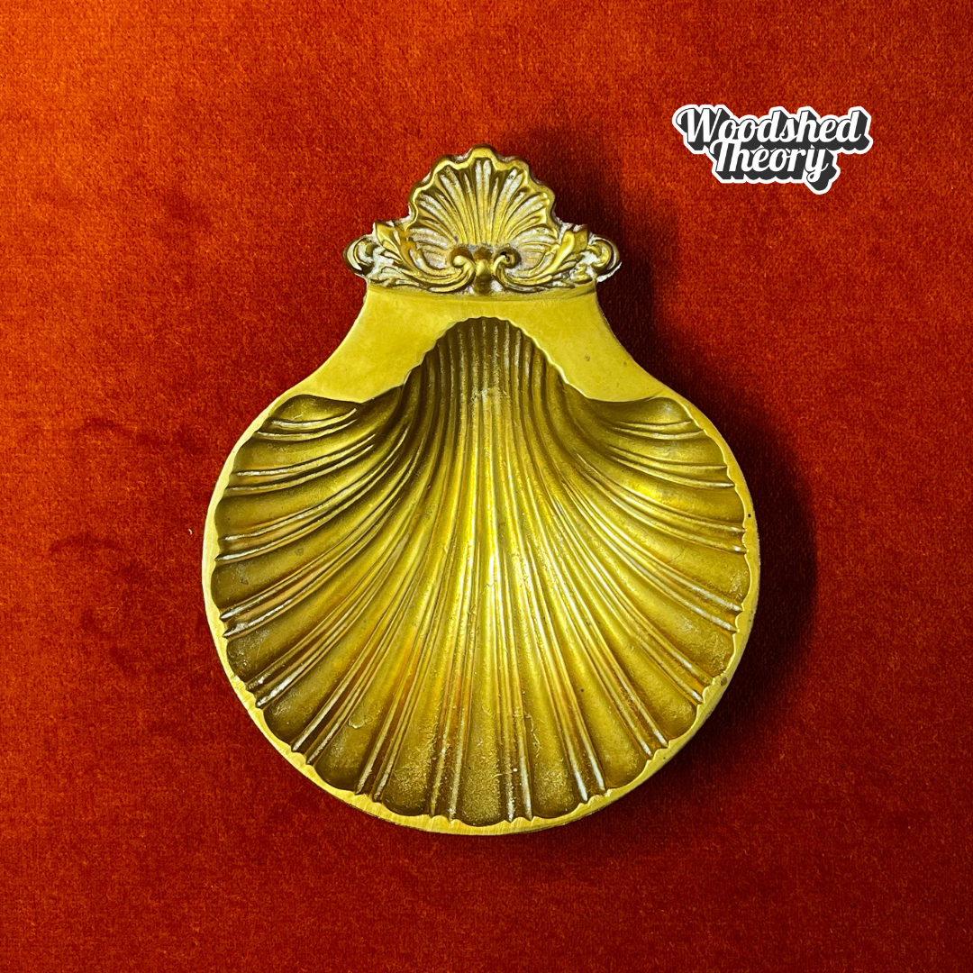 Small vintage bronze shell-shaped trinket dish on pedestal feet, made in India top down