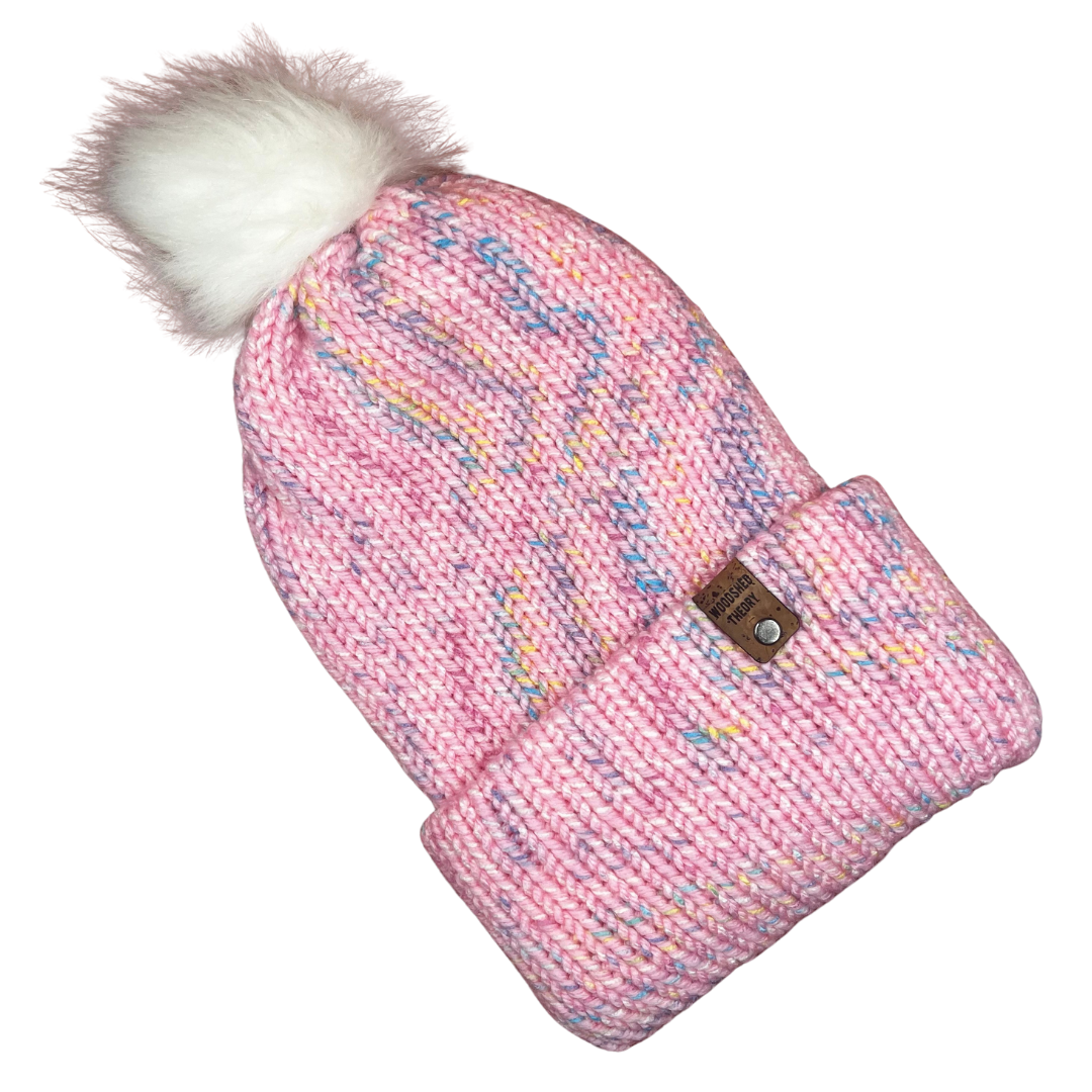 Pink knitted hat and mitten set with a white pom-pom on a white background spring beanie in pink front