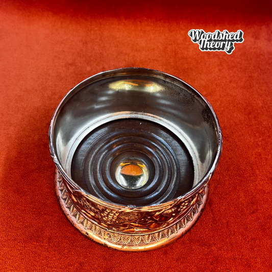 Fine English silver plate wine bottle coaster with cherub and grape design on a wood base. inside