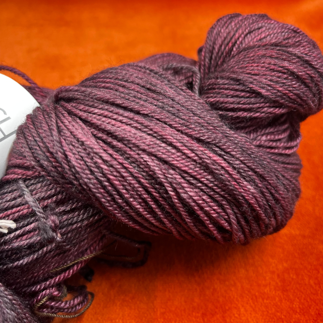 One skein of Madeline Tosh Pashmina yarn in Oxblood – a hand-dyed sport weight blend of merino, silk, and cashmere. close up