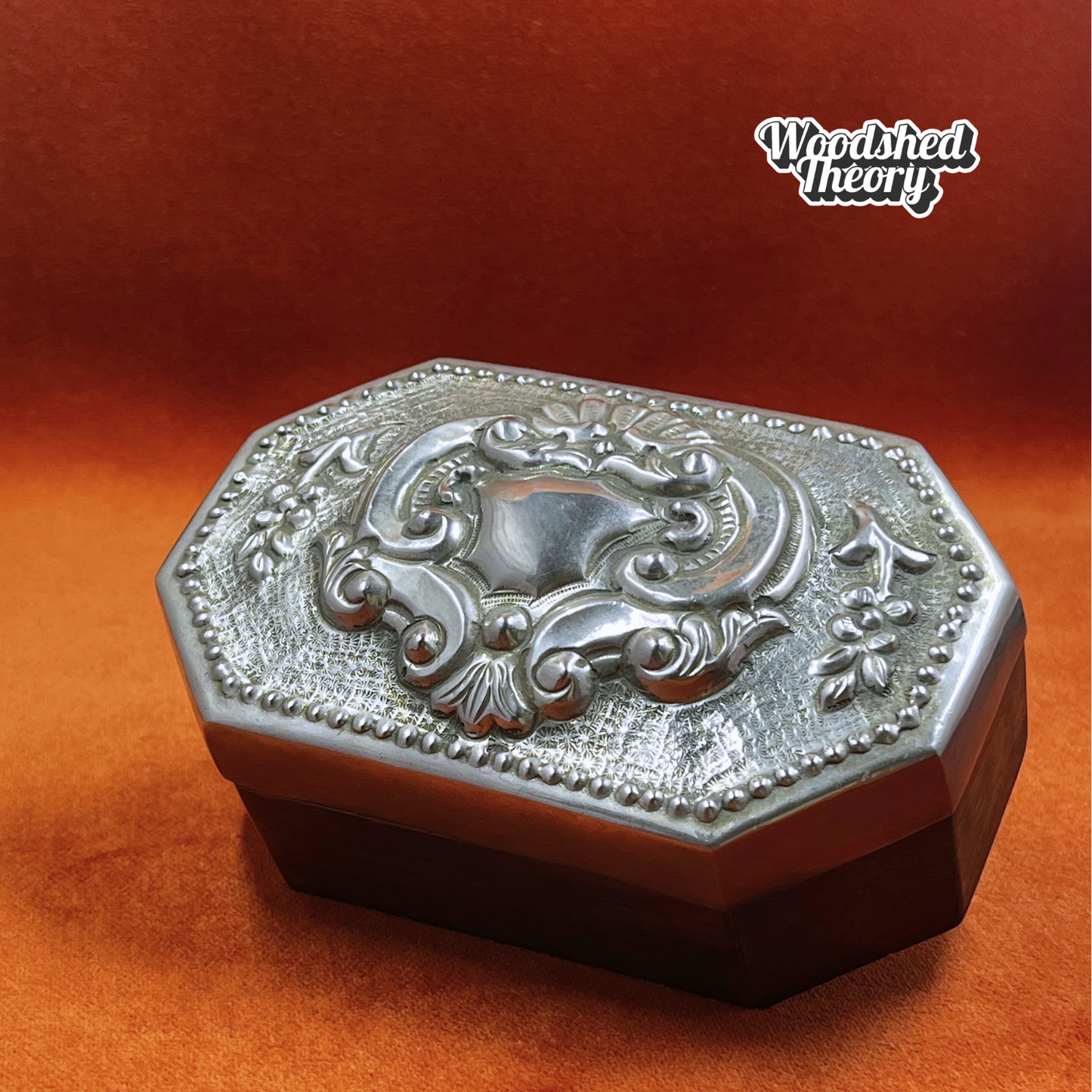 Vintage wood oval trinket box with pewter repousse lid featuring romantic filigree crest. front closed