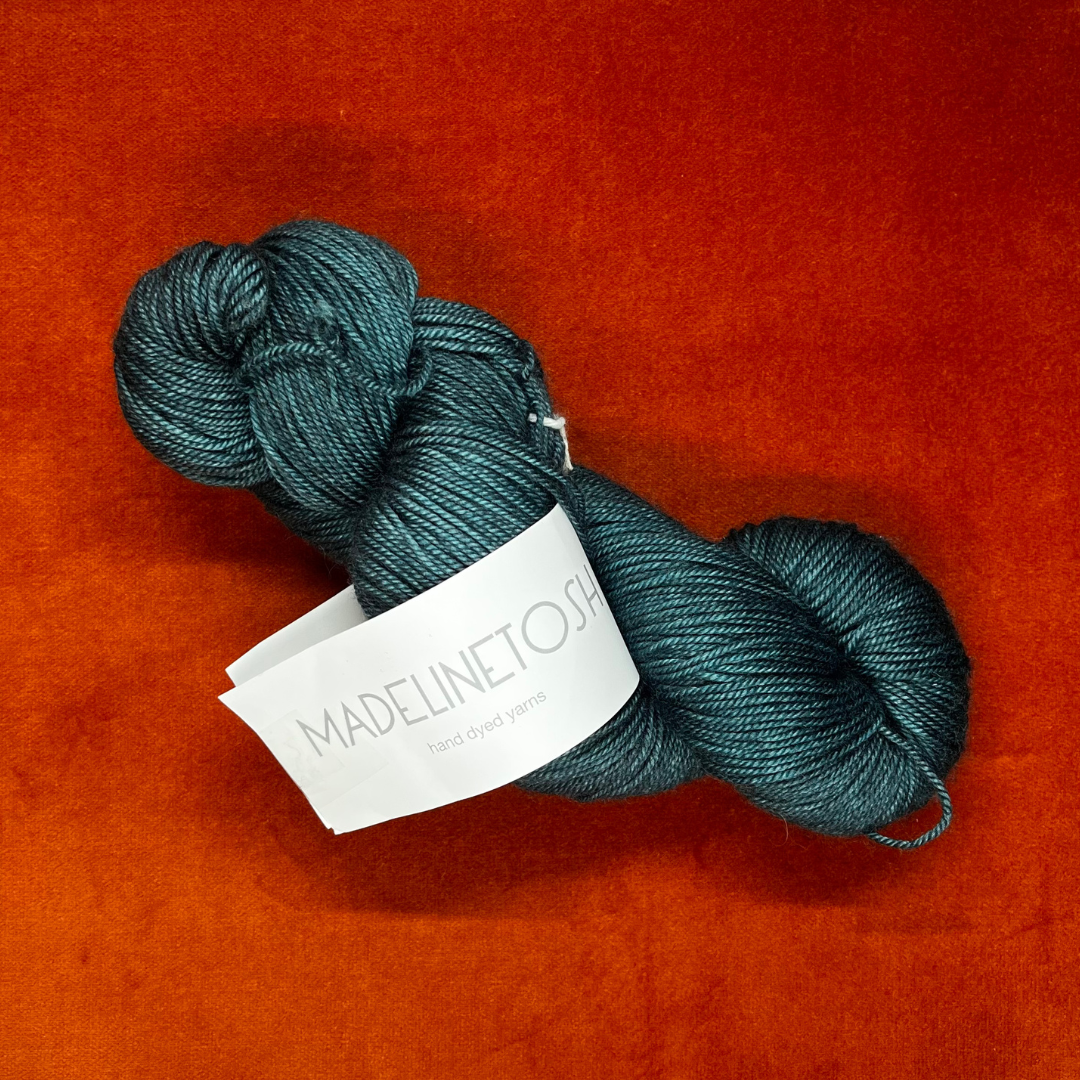 One skein of Madeline Tosh Pashmina yarn in Norway Spruce – a hand-dyed sport weight blend of merino, silk, and cashmere in deep green tones. top down