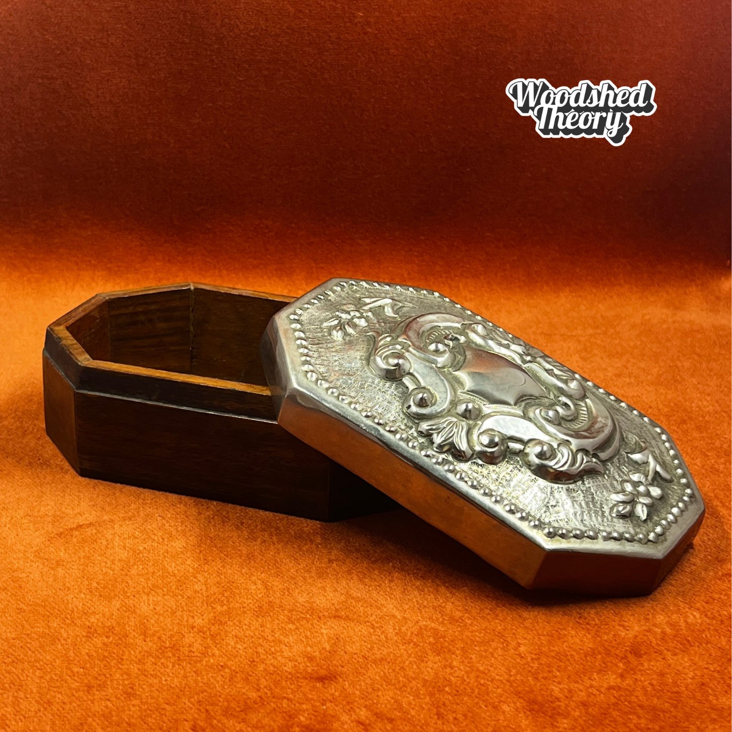 Vintage wood oval trinket box with pewter repousse lid featuring romantic filigree crest. opened