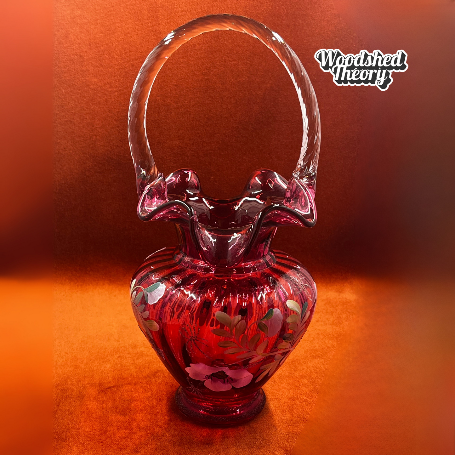 Fenton Art Glass cranberry basket with clear twisted handle, hand painted poppies, and gold glitter, signed by the artist. full image