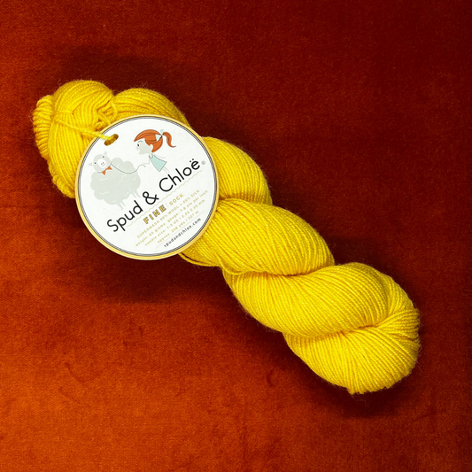 Hank of Spud and Chloe Fine sock yarn in sunny yellow color 7811, fingering weight wool and silk blend, 248 yards. above