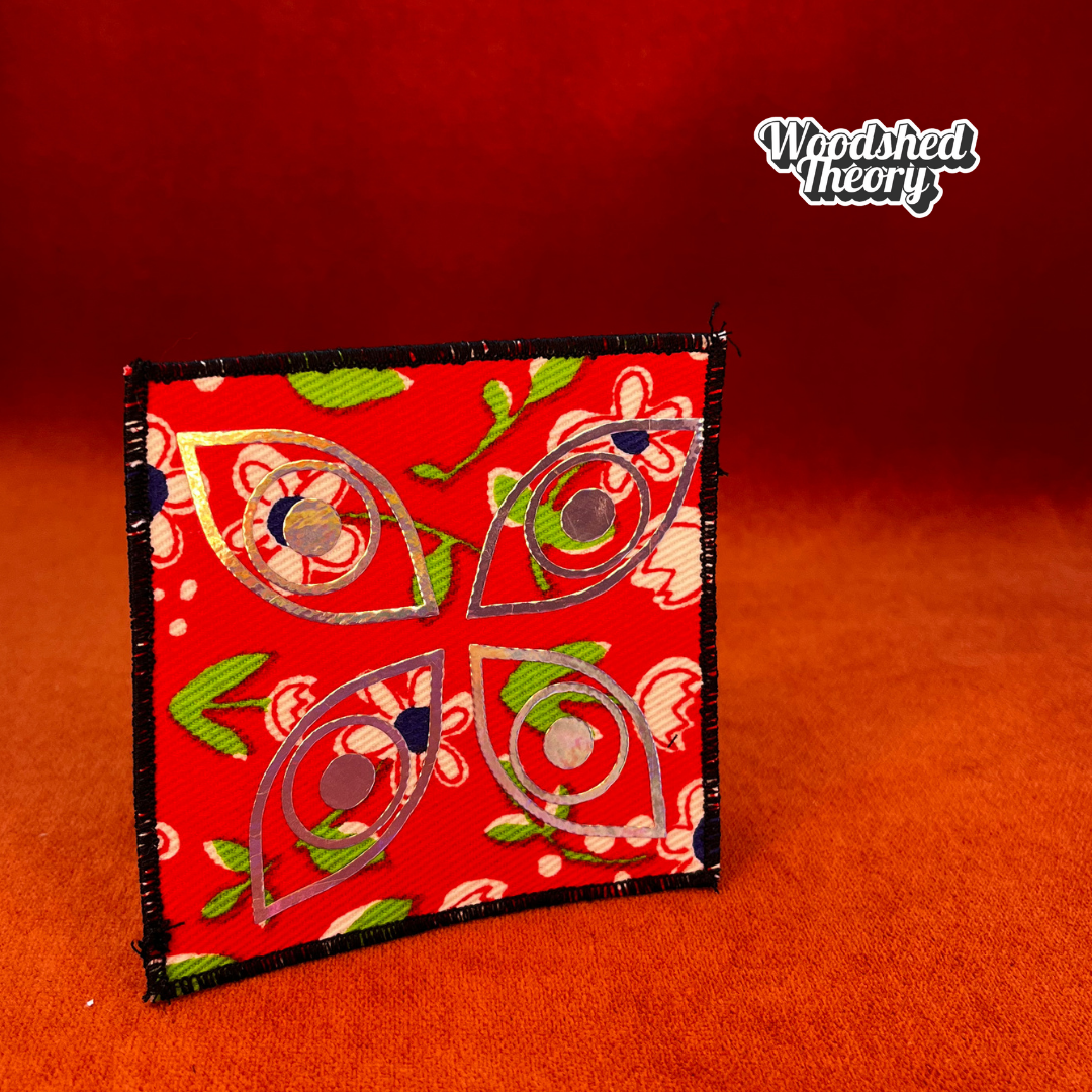Square iron-on patch with four holographic eyes arranged like a butterfly on red vintage floral canvas. Approx. 4 x 4 inches. sensory issues autism patch