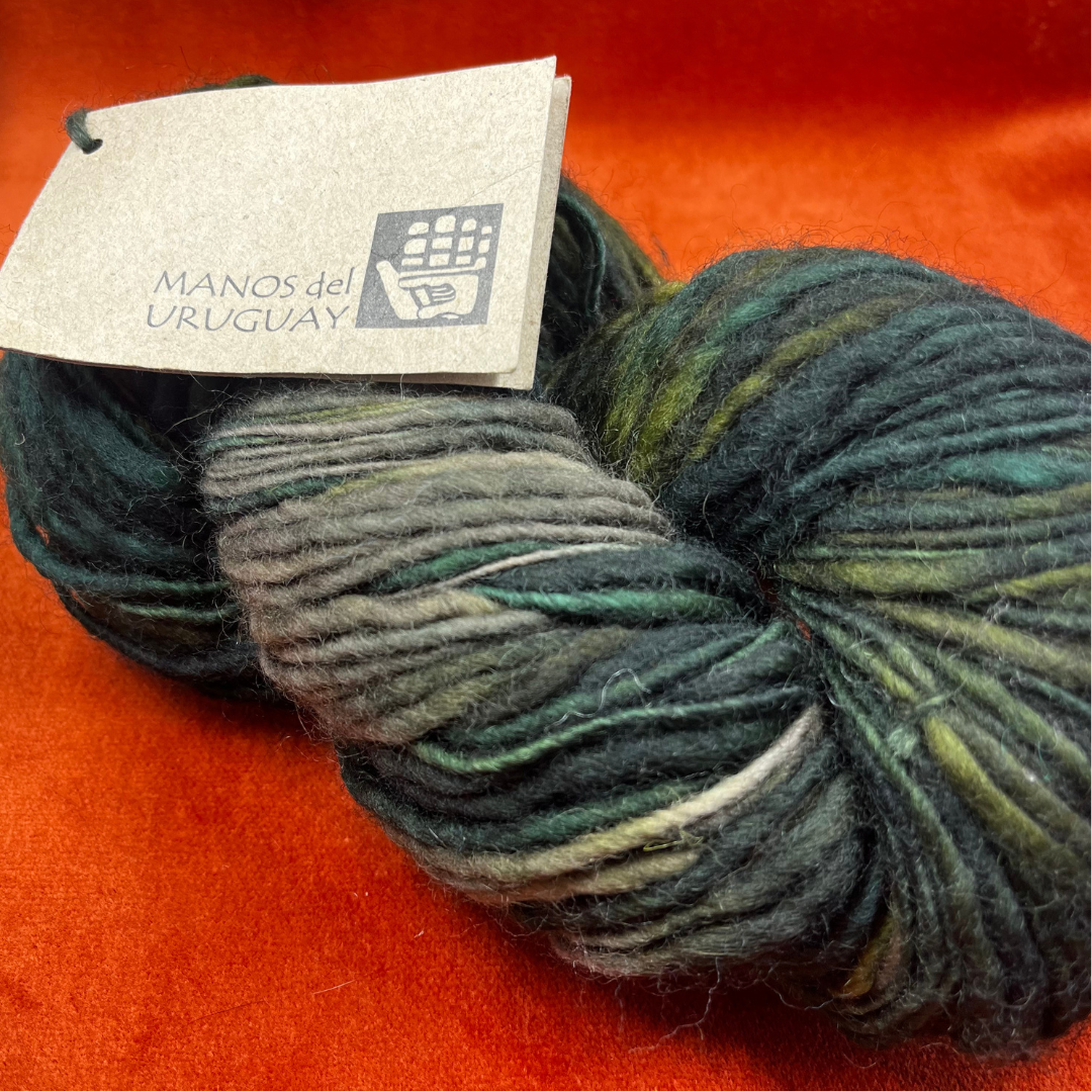 MANOS del Uruguay pure wool kettle dyed yarn in Color 101 (greens and taupe). 138 yards of roving-weight artisan wool. Handcrafted, fair trade. close up