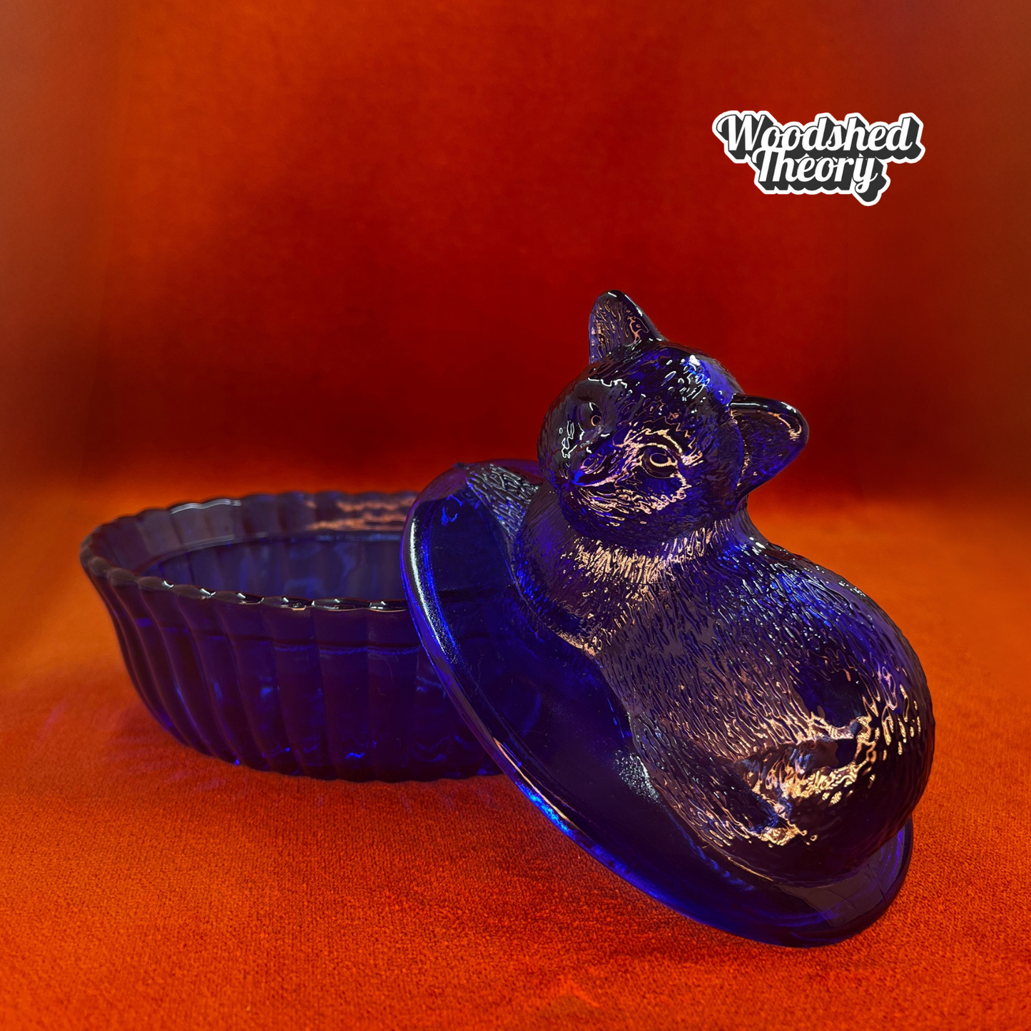 Vintage Westmoreland cobalt blue glass cat on nest dish with lid, shown from side angle. open lid