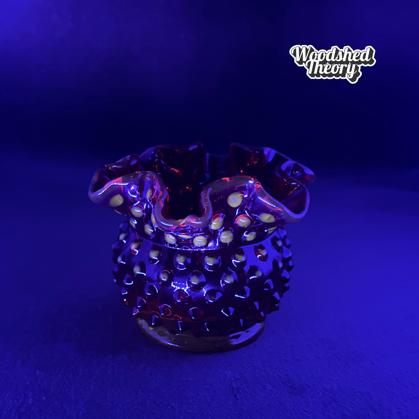 Fenton Amberina hobnail textured red-orange glass candle holder glowing orange under black light black light sample