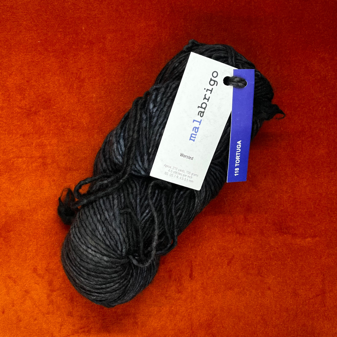 A skein of Malabrigo Worsted Roving in Tortuga, showing tonal gray and green hues in soft, single-ply merino wool. top down