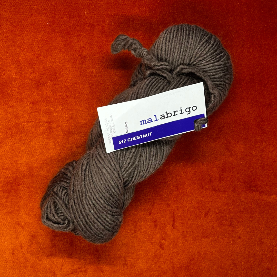One hank of Malabrigo Worsted Roving yarn in 512 Chestnut, a rich, cool brown merino wool skein. top down