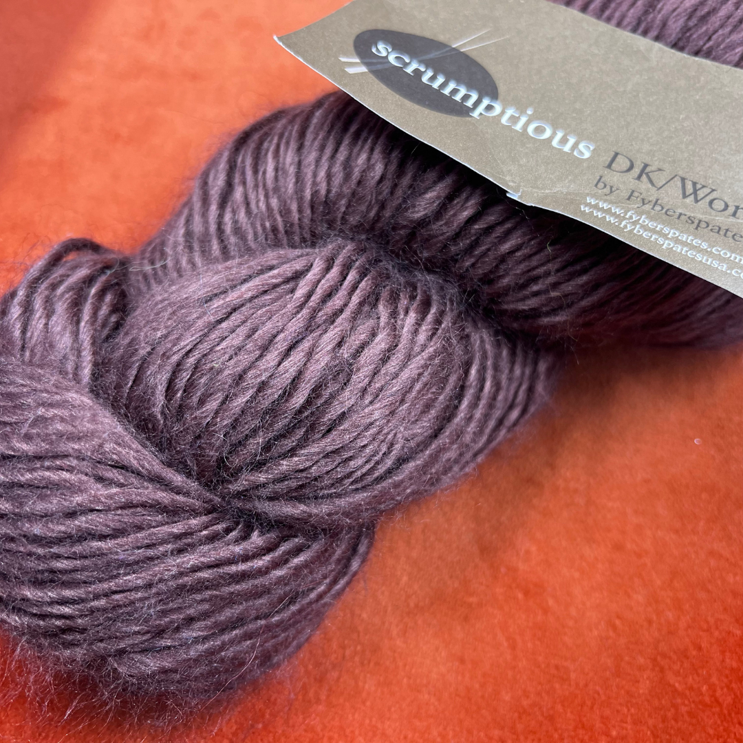 One hank of Fyberspates Scrumptious DK/Worsted yarn in color 80114 Brown, a glossy silk and merino wool blend. close up color