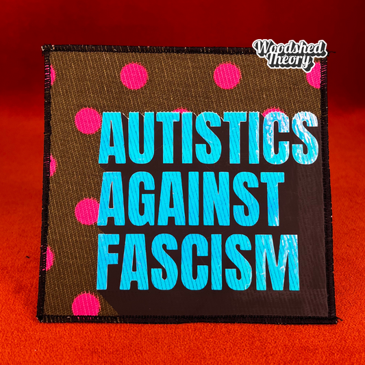 Square iron-on patch with "Autistics Against Fascism" in purple iridescent letters on olive green fabric with pink polka dots. Approx. 4.5 inches square. good trouble front