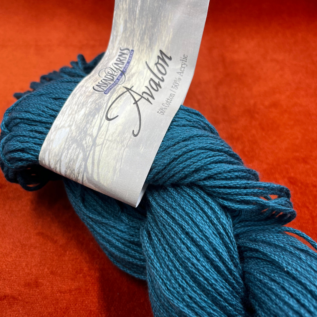 Cascade Avalon yarn in Teal (Color 31), 1 hank of aran weight cotton-acrylic blend yarn. close up with label