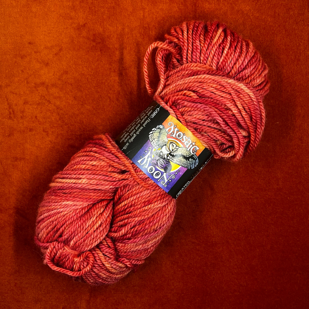 Hank of Mosaic Moon BLF Aran yarn in Persica S.S., a coral pink 100% Bluefaced Leicester wool yarn, approx. 205 yards. top down
