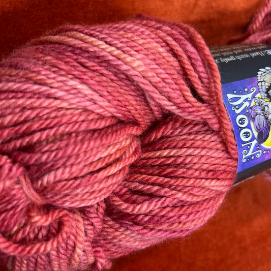 Hank of Mosaic Moon BLF Aran yarn in Persica S.S., a coral pink 100% Bluefaced Leicester wool yarn, approx. 205 yards. close up