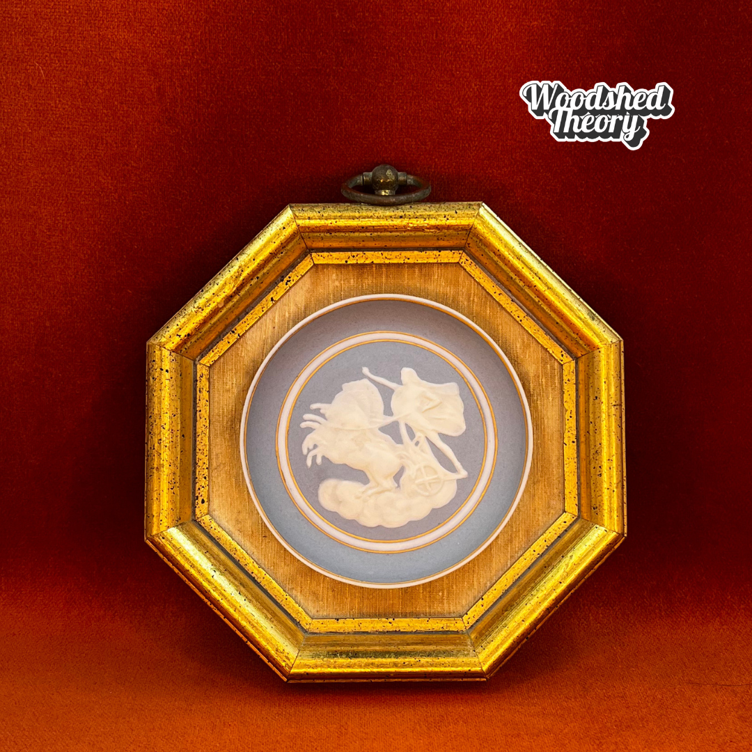 Framed vintage Camille Tharaud Limoges cameo depicting a gladiator chariot scene in white relief on blue porcelain. front