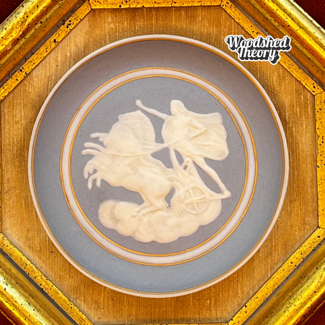 Framed vintage Camille Tharaud Limoges cameo depicting a gladiator chariot scene in white relief on blue porcelain. close up