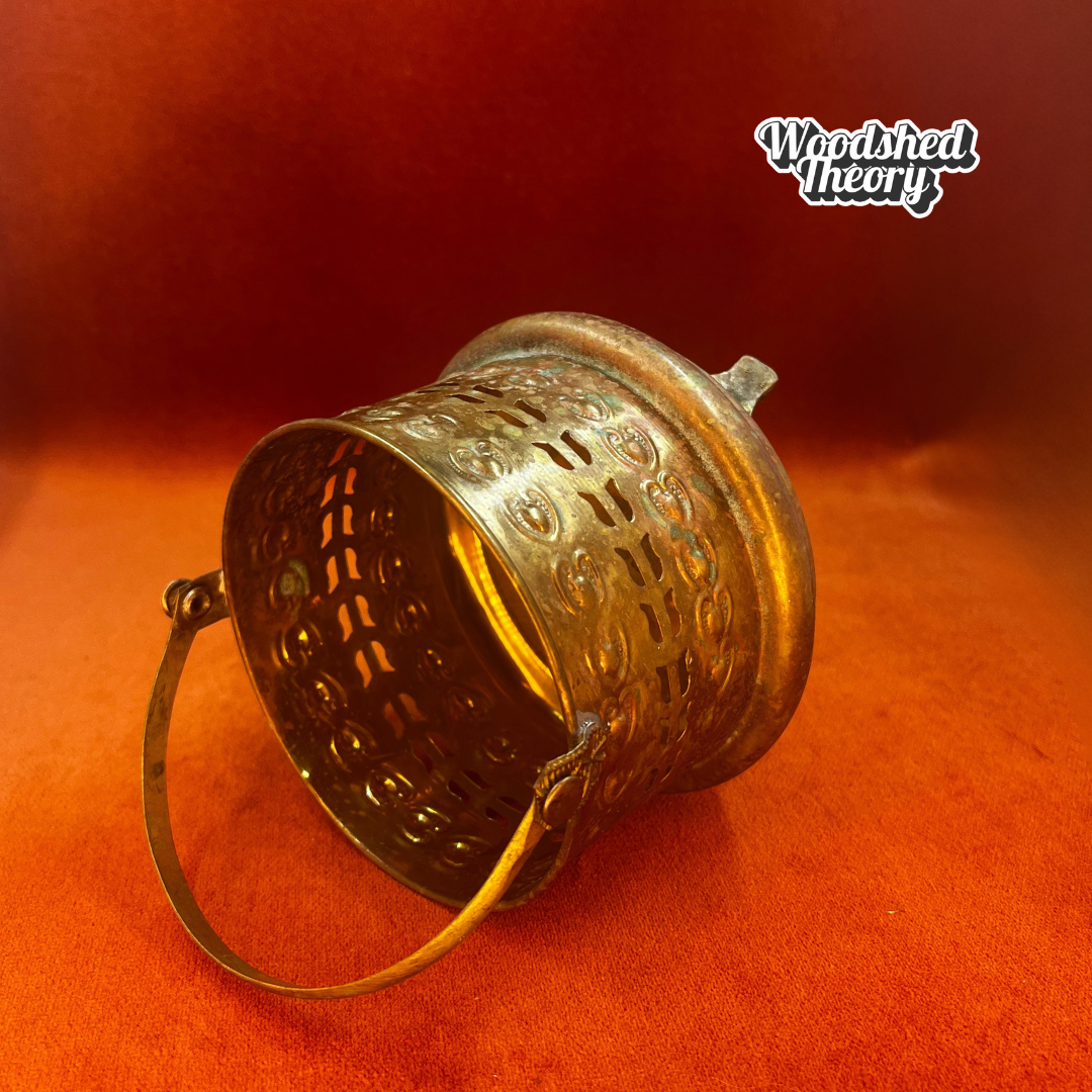 Small vintage Moroccan-style brass basket with posable handle and aged patina; perfect for candles or incense. on side