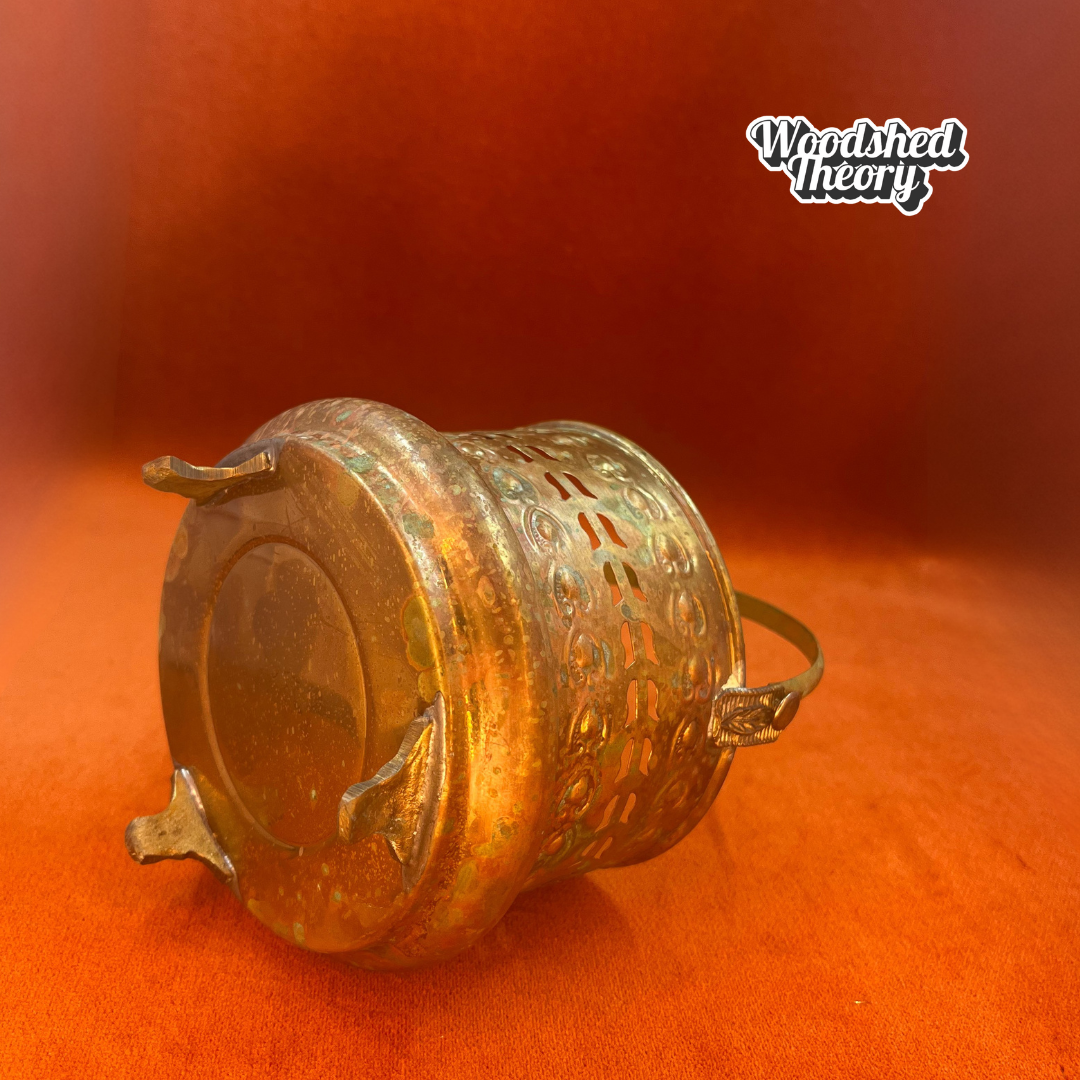 Small vintage Moroccan-style brass basket with posable handle and aged patina; perfect for candles or incense. bottom side
