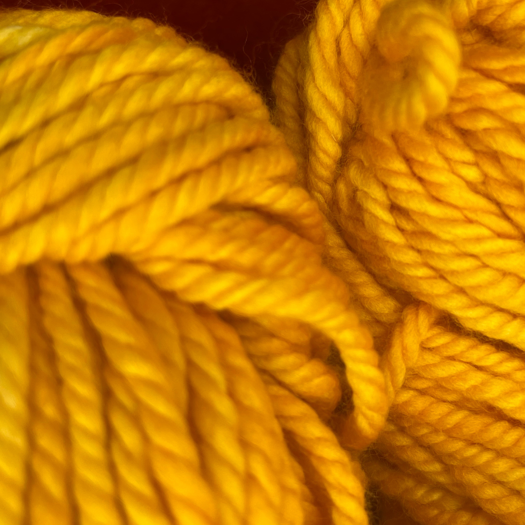 Two hanks of Malabrigo Chunky yarn in 7 Cadmium, a bright yellow 100% merino wool yarn, 200 yards total. super close up