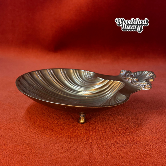 Small vintage bronze shell-shaped trinket dish on pedestal feet, made in India side profile 