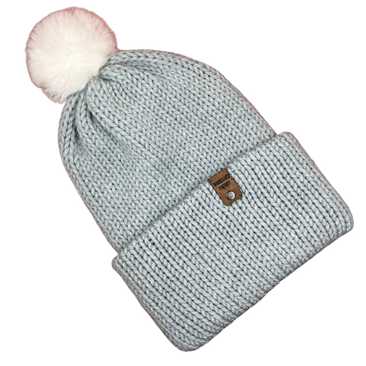 Knitted beanie with pom-pom on a white background basic beanie in ice blue soft with white pom pom flat front 