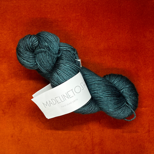 One skein of Madeline Tosh Pashmina yarn in Norway Spruce – a hand-dyed sport weight blend of merino, silk, and cashmere in deep green tones. top down