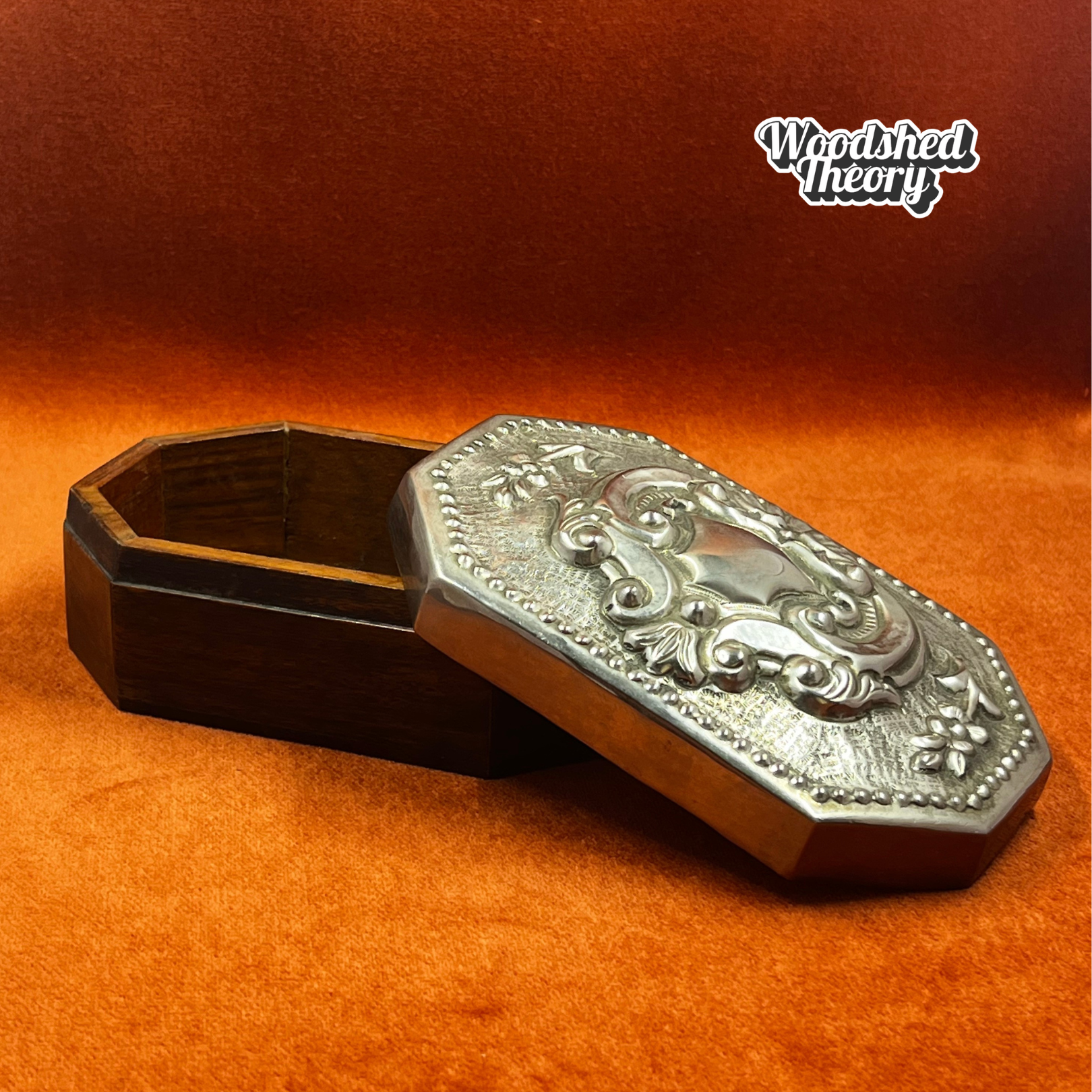 Vintage wood oval trinket box with pewter repousse lid featuring romantic filigree crest. opened