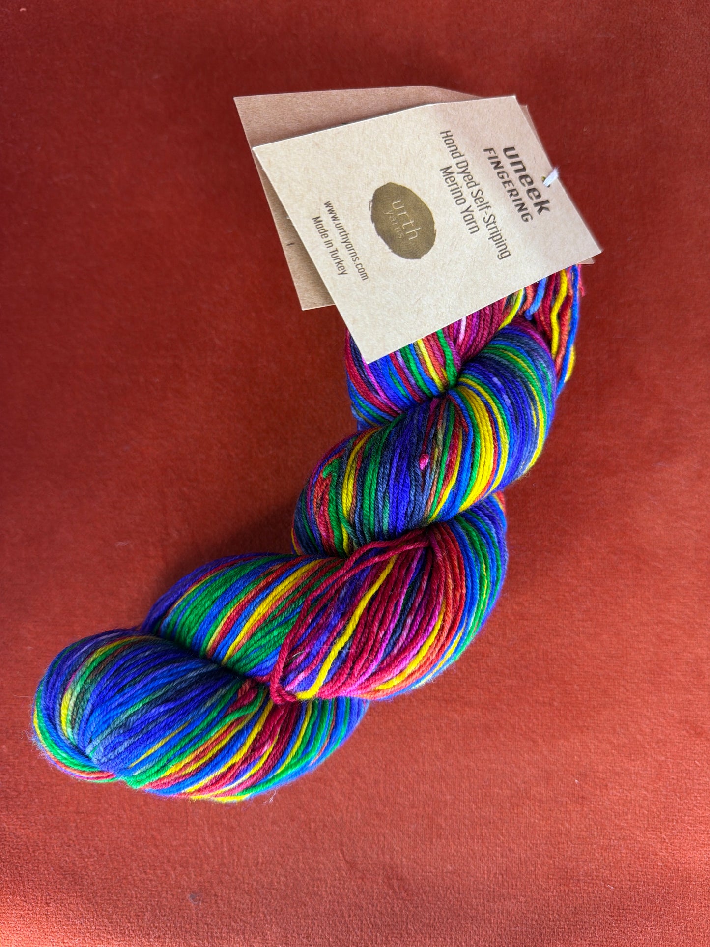 1 Hank Uneek Fingering by Urth Yarns Color 3004 (Rainbow) top down