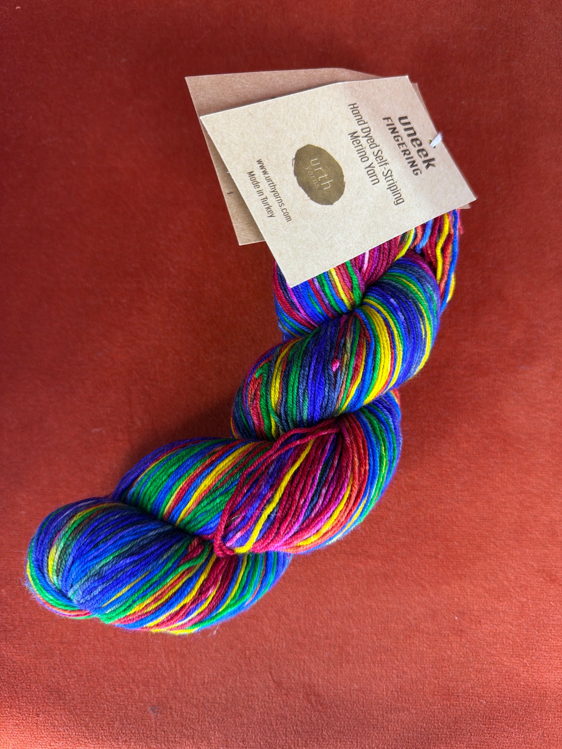 1 Hank Uneek Fingering by Urth Yarns Color 3004 (Rainbow) top down