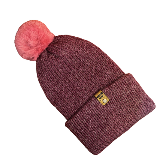 Maroon knit beanie with pink pom-pom on a white background the wooly beanie in rosie seduction dark pink front