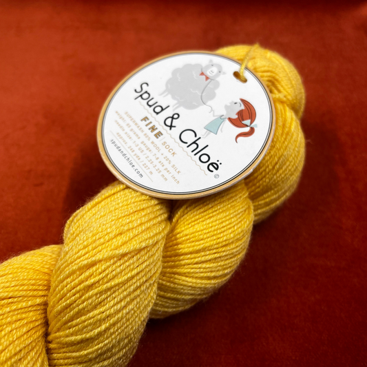 Hank of Spud and Chloe Fine sock yarn in sunny yellow color 7811, fingering weight wool and silk blend, 248 yards. close up