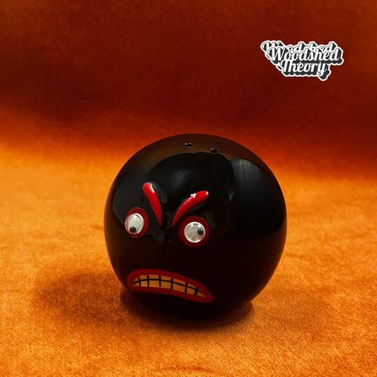 Vintage angry bowling ball pepper shaker with googly eyes from VandoRama Lanes. front view 
