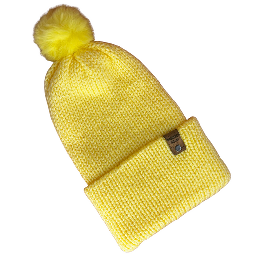 Yellow knit beanie with a pom-pom on a white background sparkle beanie yellow front flat
