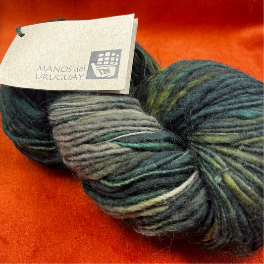 MANOS del Uruguay pure wool kettle dyed yarn in Color 101 (greens and taupe). 138 yards of roving-weight artisan wool. Handcrafted, fair trade. close up 