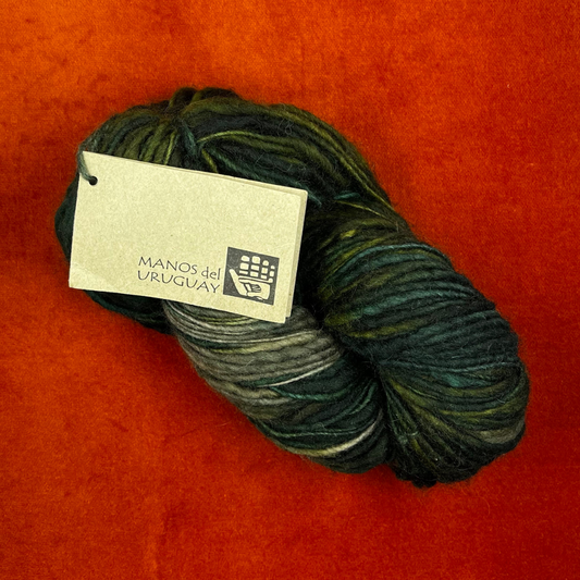 MANOS del Uruguay pure wool kettle dyed yarn in Color 101 (greens and taupe). 138 yards of roving-weight artisan wool. Handcrafted, fair trade. top down