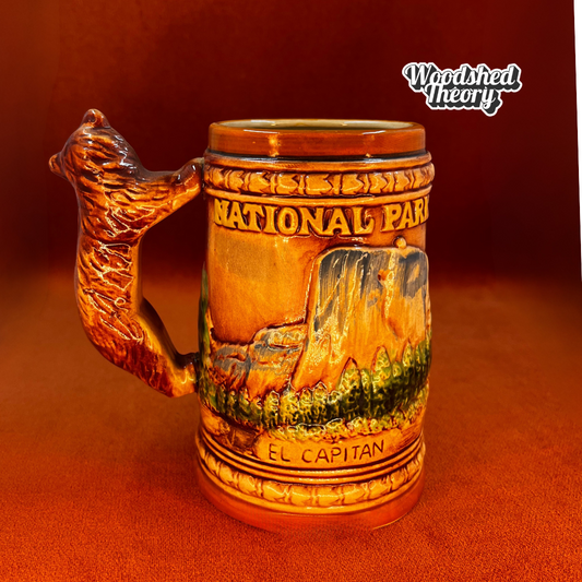 Vintage 1950s ceramic Yosemite souvenir mug with California bear handle and raised reliefs of Half Dome and El Capitan. back 