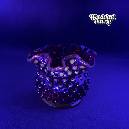 Fenton Amberina hobnail textured red-orange glass candle holder glowing orange under black light black light sample