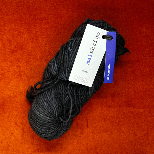 A skein of Malabrigo Worsted Roving in Tortuga, showing tonal gray and green hues in soft, single-ply merino wool. top down 