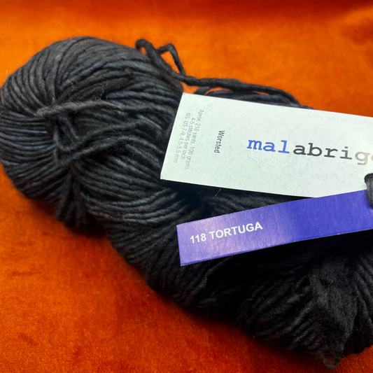 A skein of Malabrigo Worsted Roving in Tortuga, showing tonal gray and green hues in soft, single-ply merino wool. close up 