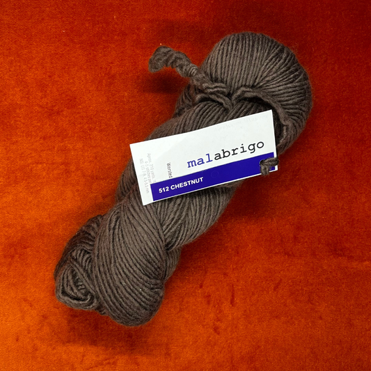 One hank of Malabrigo Worsted Roving yarn in 512 Chestnut, a rich, cool brown merino wool skein. top down