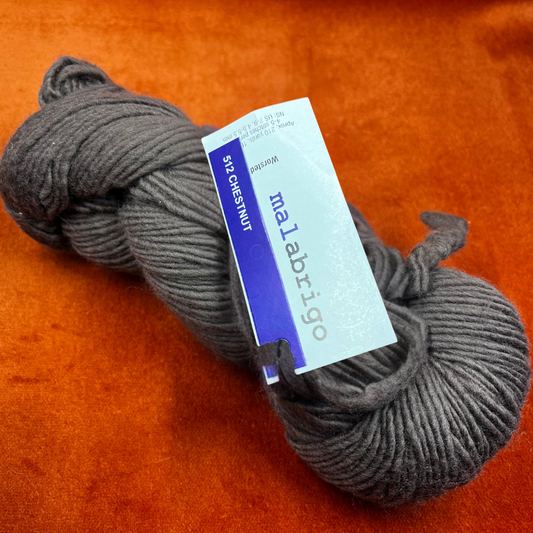 One hank of Malabrigo Worsted Roving yarn in 512 Chestnut, a rich, cool brown merino wool skein. close up 