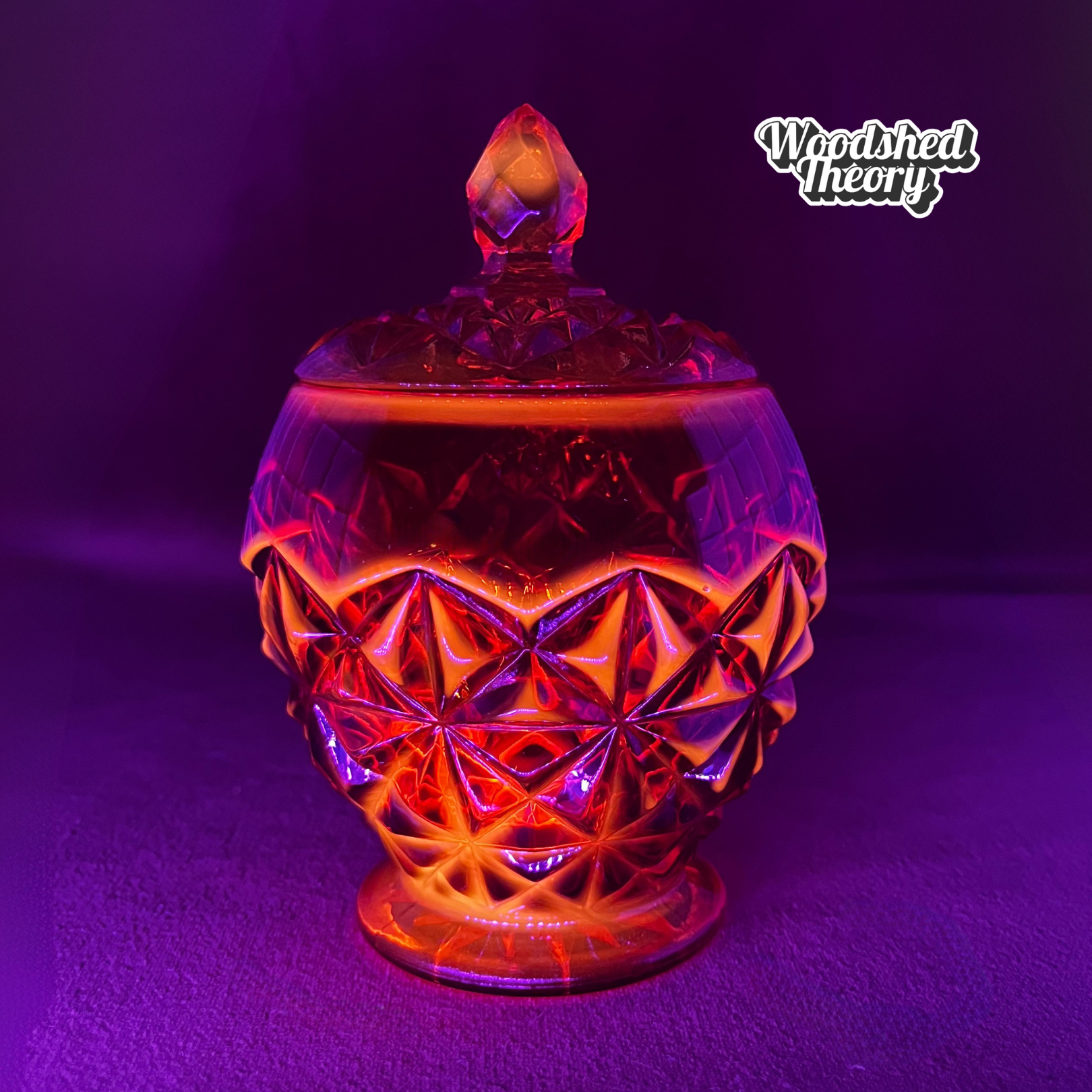 Indiana Glass Amberina faceted red-orange glass candy dish with lid, cadmium glow under black light black light example