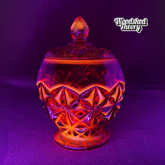 Indiana Glass Amberina faceted red-orange glass candy dish with lid, cadmium glow under black light black light example