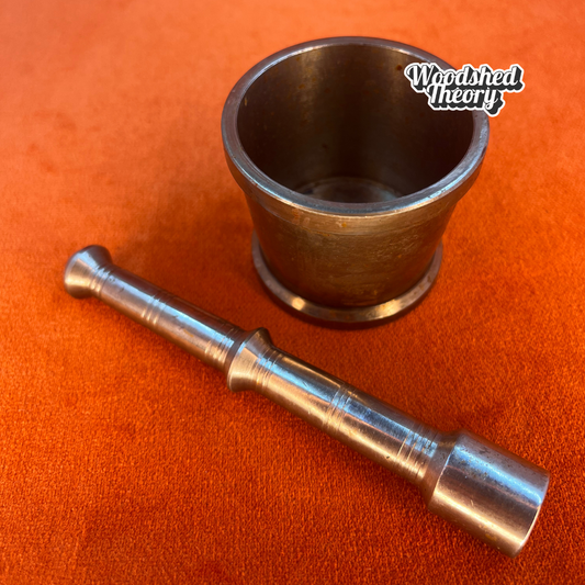 Vintage miniature silver metal mortar and pestle with patina and "O S" stamp on base. close up pestle