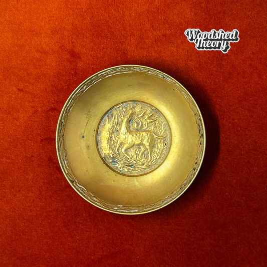 Solid bronze vintage ring dish showing a fawn walking in a wooded scene, stamped “Korea” on the bottom. top down 