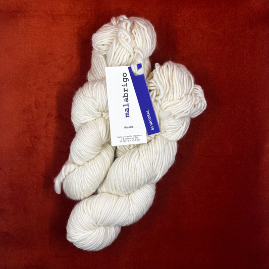 Two hanks of Malabrigo Worsted Roving yarn in Simply Taupe, a soft earthy neutral, made of 100% merino wool. top down